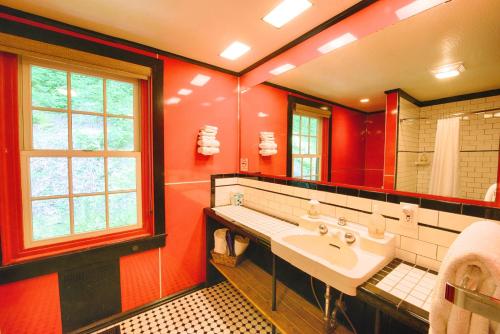 a red bathroom with a sink and a mirror at Historic Tapoco Lodge Resort in Tapoco