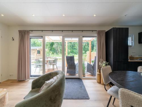 a living room with a table and chairs at Lodge in Hattemerbroek near Veluwe Forest in Hattemerbroek