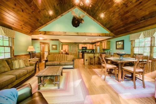 a large living room with a table with a cow head on the ceiling at Historic Tapoco Lodge Resort in Tapoco
