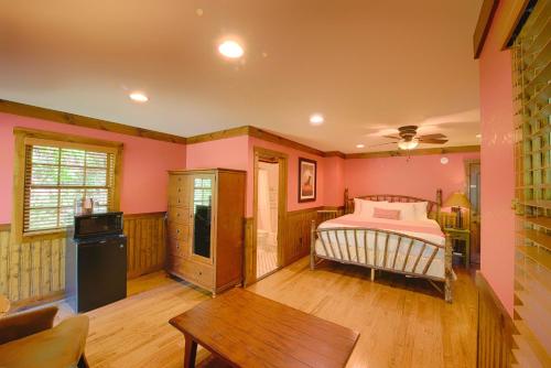 a bedroom with a bed and a table at Historic Tapoco Lodge Resort in Tapoco