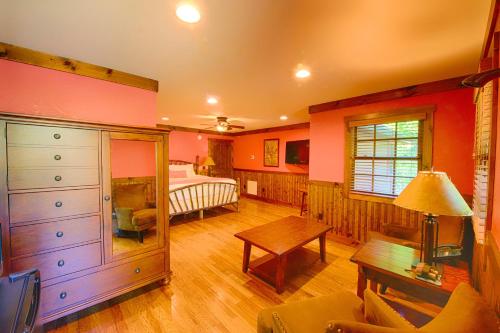 a room with a bedroom with a bed and a table at Historic Tapoco Lodge Resort in Tapoco
