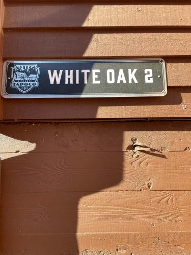 a sign that says white oak on a brown wall at Historic Tapoco Lodge Resort in Tapoco