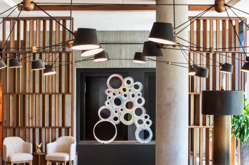 a lobby with chairs and a door with a sculpture at Moxy Boulder University in Boulder