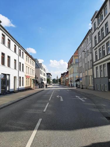 an empty street in a city with buildings at City-Apartment 1 in Schwerin