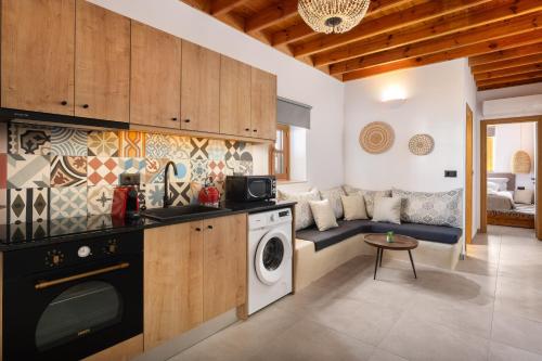 a kitchen with a washer and dryer in a room at Tapanis luxury house in Líndos