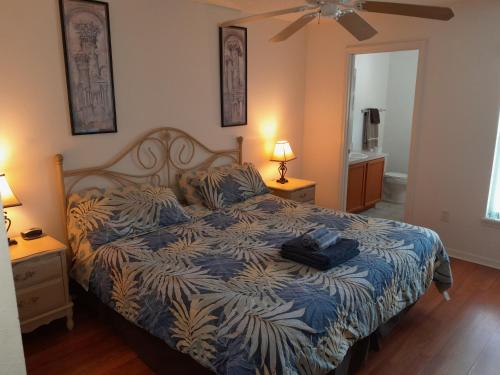a bedroom with a bed with a blue and white comforter at Three-Bedroom House in Clear Creek in Orlando