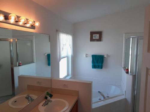 a bathroom with a sink and a mirror at Three-Bedroom House in Clear Creek in Orlando