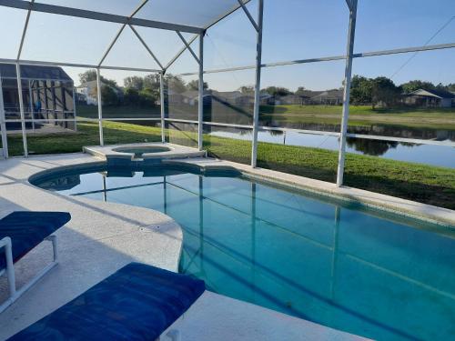 a swimming pool with a view of a lake at Three-Bedroom House in Clear Creek in Orlando