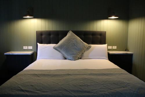 a large bed with two pillows and two night stands at Dusty Hill Vineyard - Moffatdale in Moffatdale