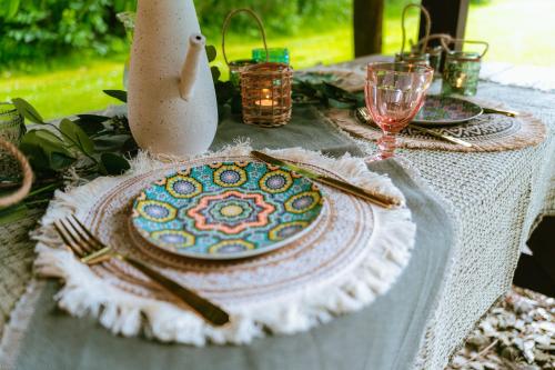 a table with a plate of food on it at Chata w Leśnych Pieleszach - sauna & balia z jacuzzi na wyłączność in Łukawica