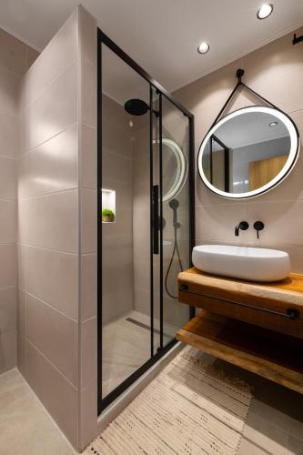 a bathroom with a sink and a mirror at Tapanis luxury house in Lindos