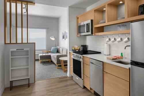 a kitchen and living room in a apartment at TownePlace Suites by Marriott Coeur d'Alene in Coeur d'Alene