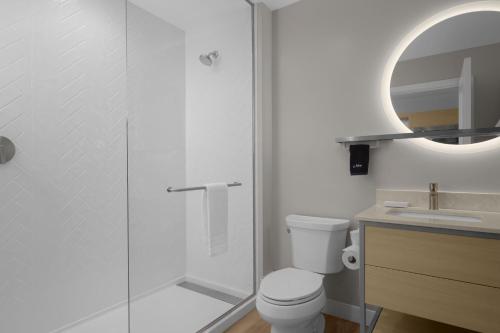 a bathroom with a shower and a toilet and a sink at TownePlace Suites by Marriott Coeur d'Alene in Coeur d'Alene
