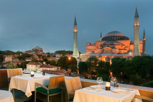 a large building with a large clock on top of it at The And Hotel Sultanahmet- Special Category in Istanbul