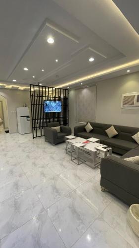 a living room with couches and a flat screen tv at Kinda Resort Luxury Villas in Taif