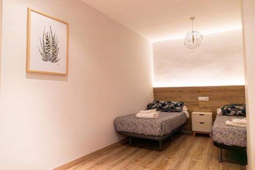 a room with two beds and a mirror at ENCANTO CUENCA Balcones De La Historia in Cuenca