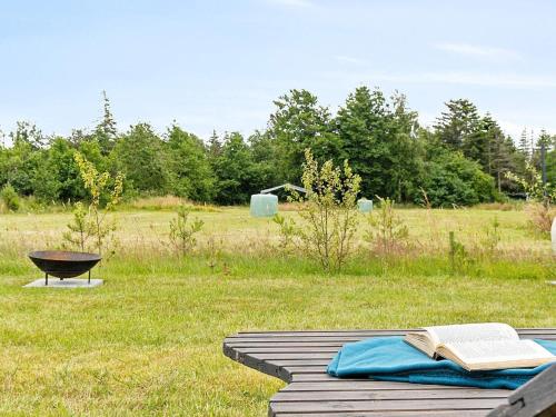 an open book on a table in a field at Luxury Retreat in albaek - By Traum Ferienwohnungen in Ålbæk