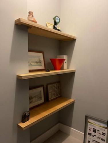 a room with wooden shelves on the wall at Prédio Histórico na Rio Branco in Caxias do Sul