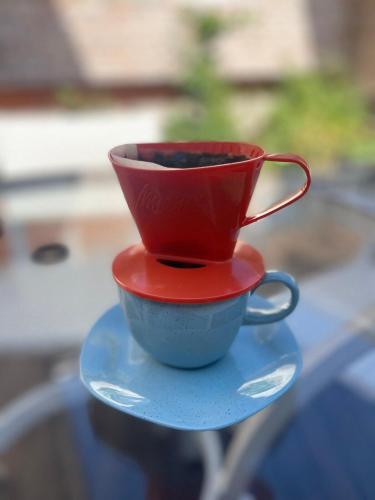 a red coffee cup sitting on top of a table at Prédio Histórico na Rio Branco in Caxias do Sul