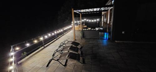 a bench sitting on a patio at night at Bella Vista Cheia in Cheia