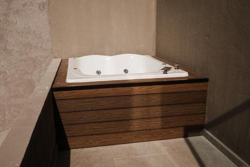 a bath tub sitting on top of a wooden cabinet in a bathroom at Loft303 in Aguascalientes