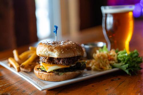 a hamburger and french fries and a glass of beer at Atlantic Pub & Hotel in Glen Robertson