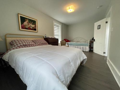 a bedroom with a large white bed in it at Atlantic Pub & Hotel in Glen Robertson