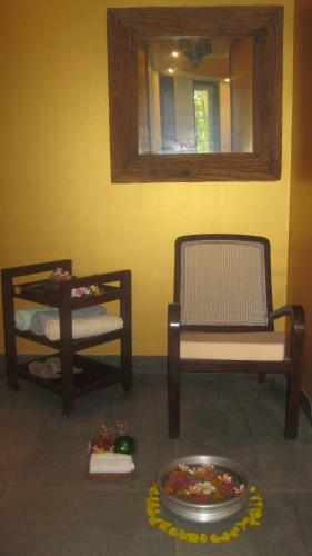 a living room with two chairs and a mirror at The Meadows Resort and Spa in Aurangabad