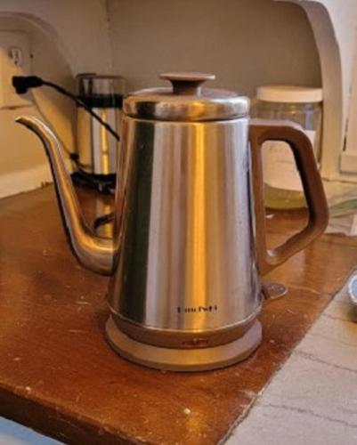 a tea kettle sitting on top of a counter at The Kings Throne Inn and Guest House in Toledo