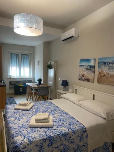 a bedroom with a large bed with towels on it at Leila's Home in Gaeta
