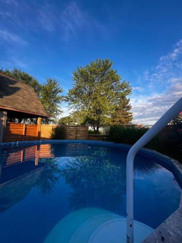 a swimming pool in a yard with a gazebo at Sunset Suites in Niagara Wine Country in Niagara on the Lake