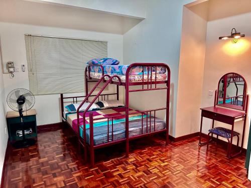 two bunk beds in a room with a fan at Seaview Seri Bulan PD Teluk Kemang Homestay in Port Dickson