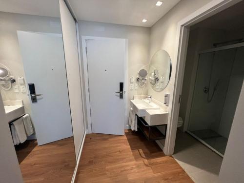 a bathroom with a sink and a mirror at Wanderlust Experience Hotel in Campos do Jordão
