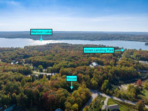 arial view of a forest with a lake at Private & Convenient-Hot tub-Fire Pit-Game room! in Petoskey