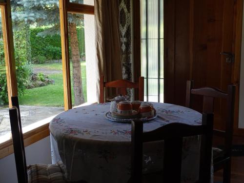 a table in a room with a view of a window at Casa Malen Llao Llao in San Carlos de Bariloche