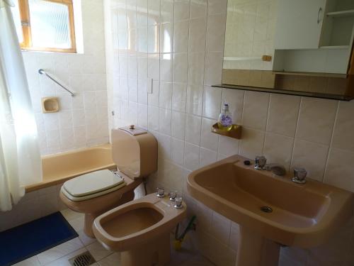 a bathroom with a toilet and a sink at Casa Malen Llao Llao in San Carlos de Bariloche