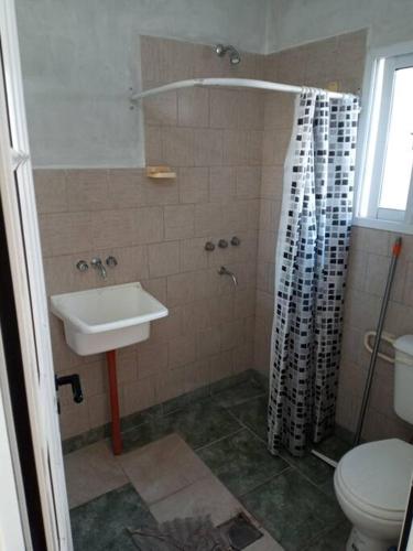 a bathroom with a sink and a shower with a toilet at comodidad y seguridad in Cañada de Gómez