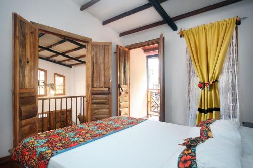 a bedroom with a bed and a window at El Encanto Mountain Cabin in Salento