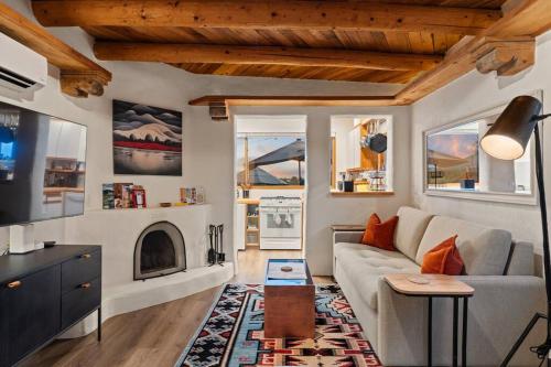 a living room with a couch and a fireplace at Scenic Santa Fe Downtown Escape in Santa Fe