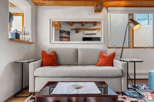 a living room with a couch and a table at Scenic Santa Fe Downtown Escape in Santa Fe