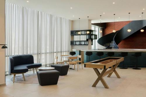 a room with a ping pong table and chairs at City Express Plus by Marriott Monterrey Centro in Monterrey