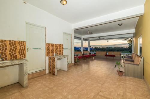an empty lobby with a view of a living room at Hotel Riverside with Swimming pool in Sauraha