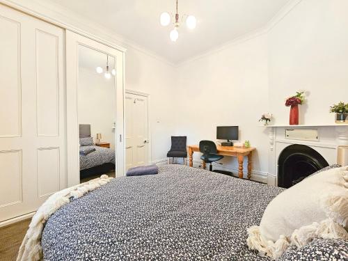 a bedroom with a bed and a desk with a computer at Unley Retreat in Unley
