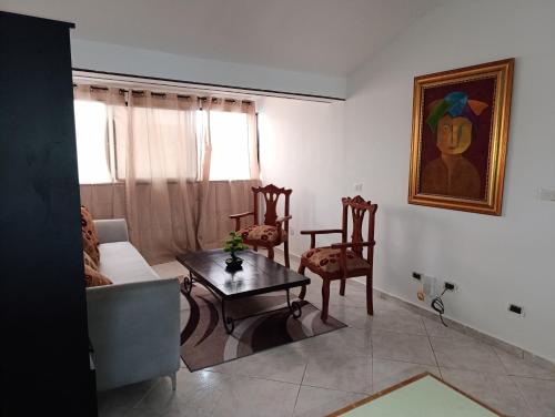 a living room with a couch and a table and chairs at Acuario residencial 1 in La Viva