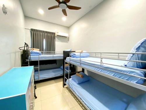 a room with three bunk beds and a ceiling fan at JOVIAL Modern Cozy Suite `Metropol BM BandarPerda in Bukit Mertajam