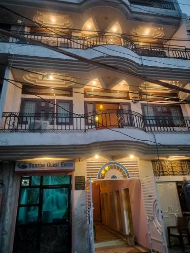 a building with a guest house with two balconies at Sunrise Guest House in Jaipur