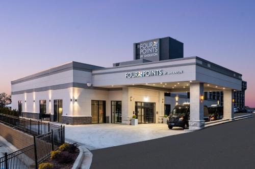 a building with a car parked in front of it at Four Points by Sheraton Atlanta Airport West in Atlanta