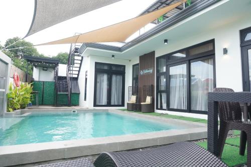 a swimming pool in the backyard of a house at A's Hideaway Pampanga in Guagua