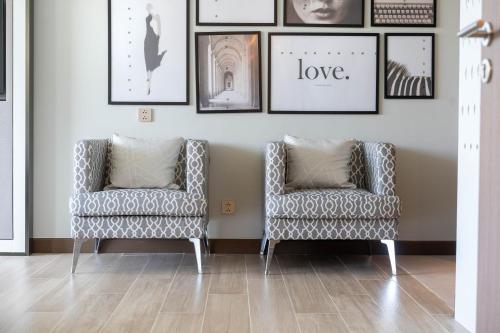 two chairs in a room with pictures on the wall at Laguna Angsana Apartments Lake View in Bang Tao Beach