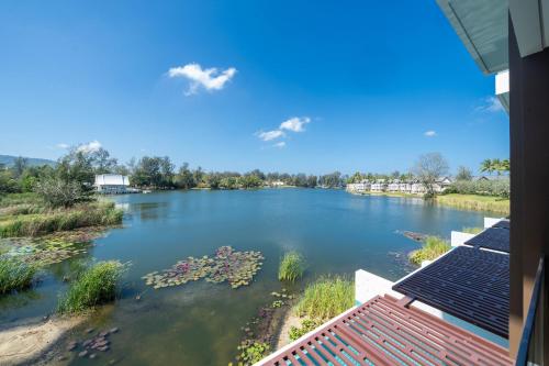 a view of a river with flowers in the water at Laguna Angsana Apartments Lake View in Bang Tao Beach